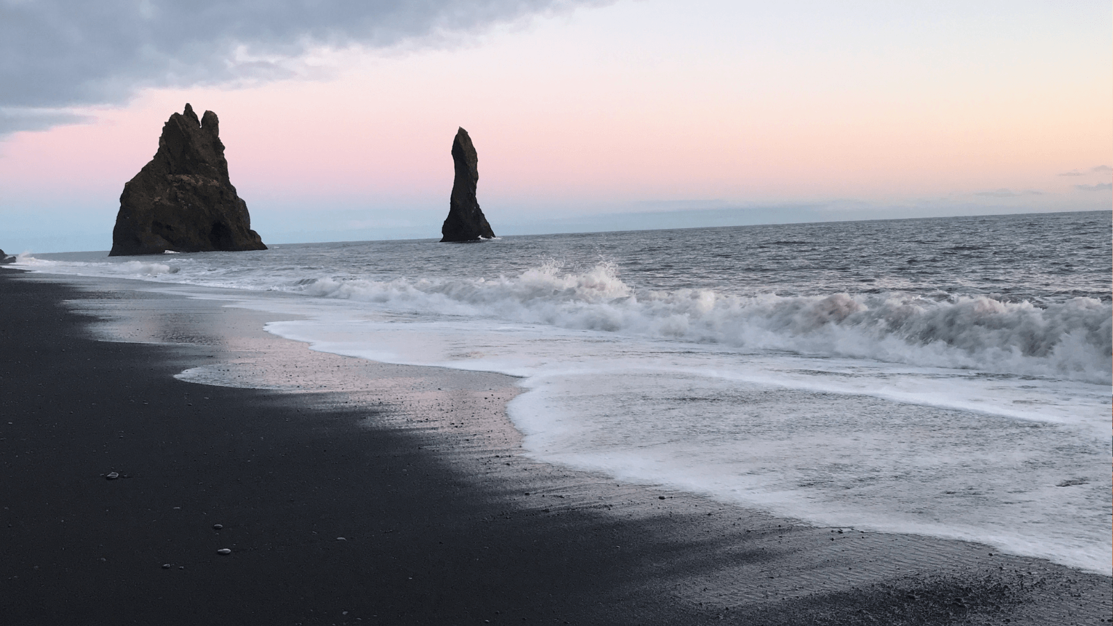 Rock formations and black sand at Reynisfjara Beach, Iceland. 