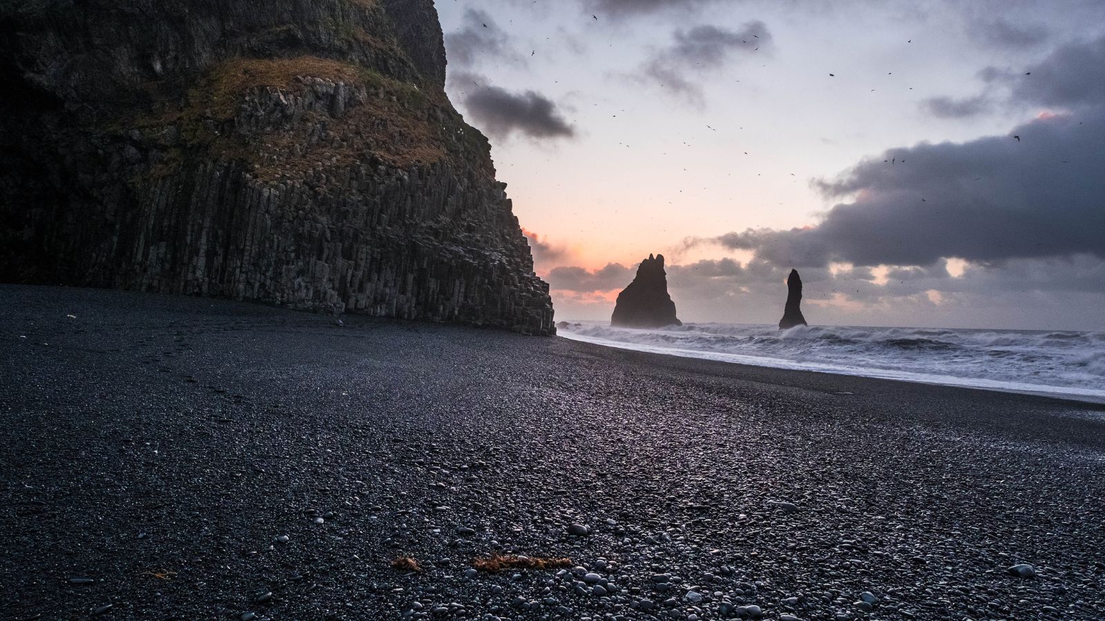 Rock formation and cliffs at Reynisfjara Black Sand Beach in Iceland.