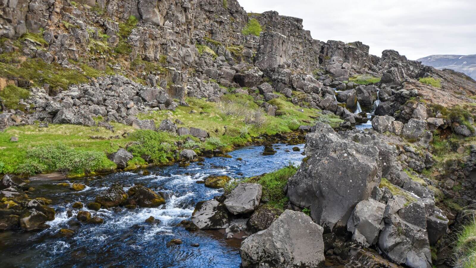 River running through rocky terrain in Thingvellir National Park on the Golden Circle route in Iceland.