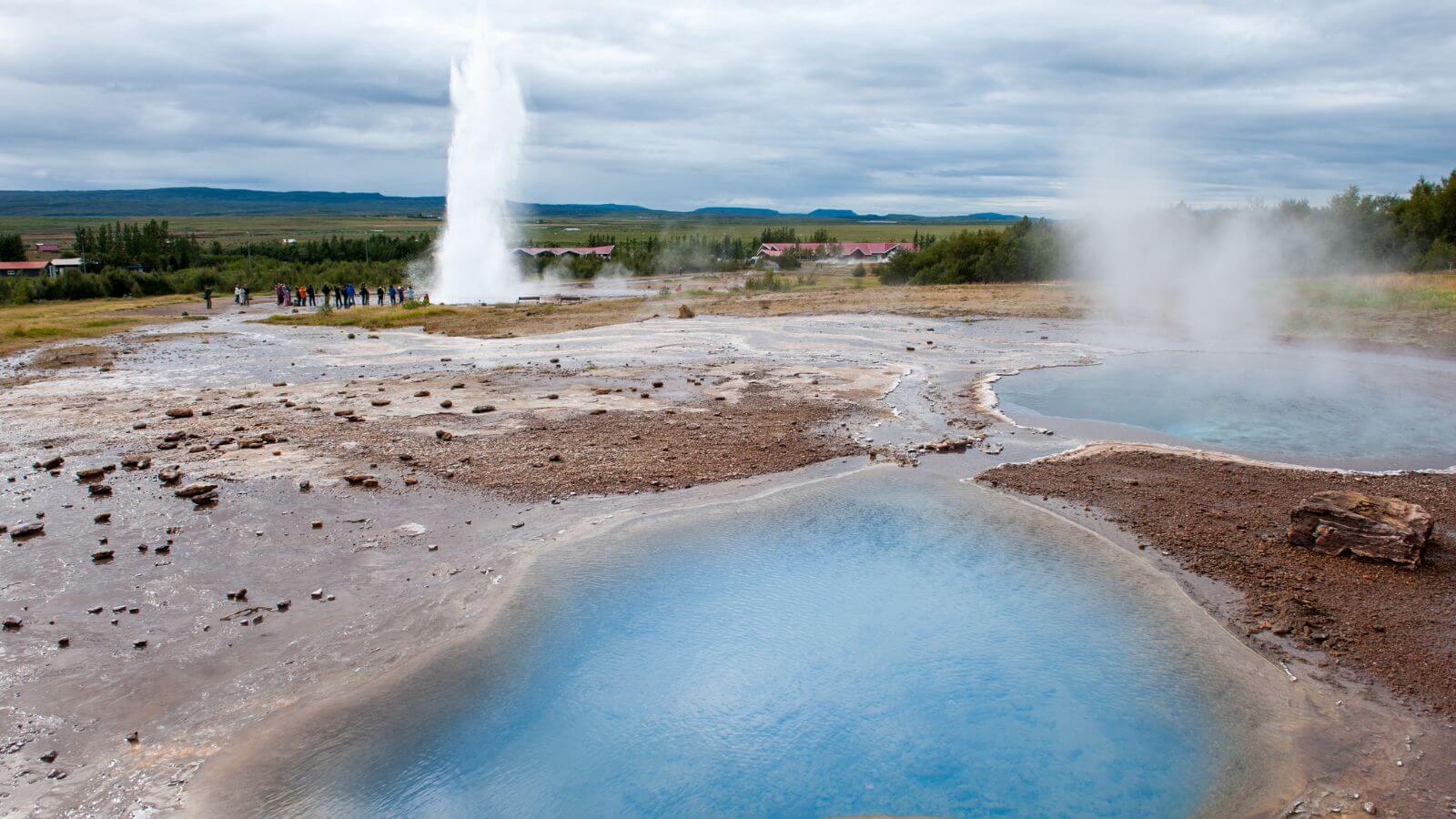 Erupting geysers and geothermal pools in the Geysir Geothermal Area on the Golden Circle in Iceland.