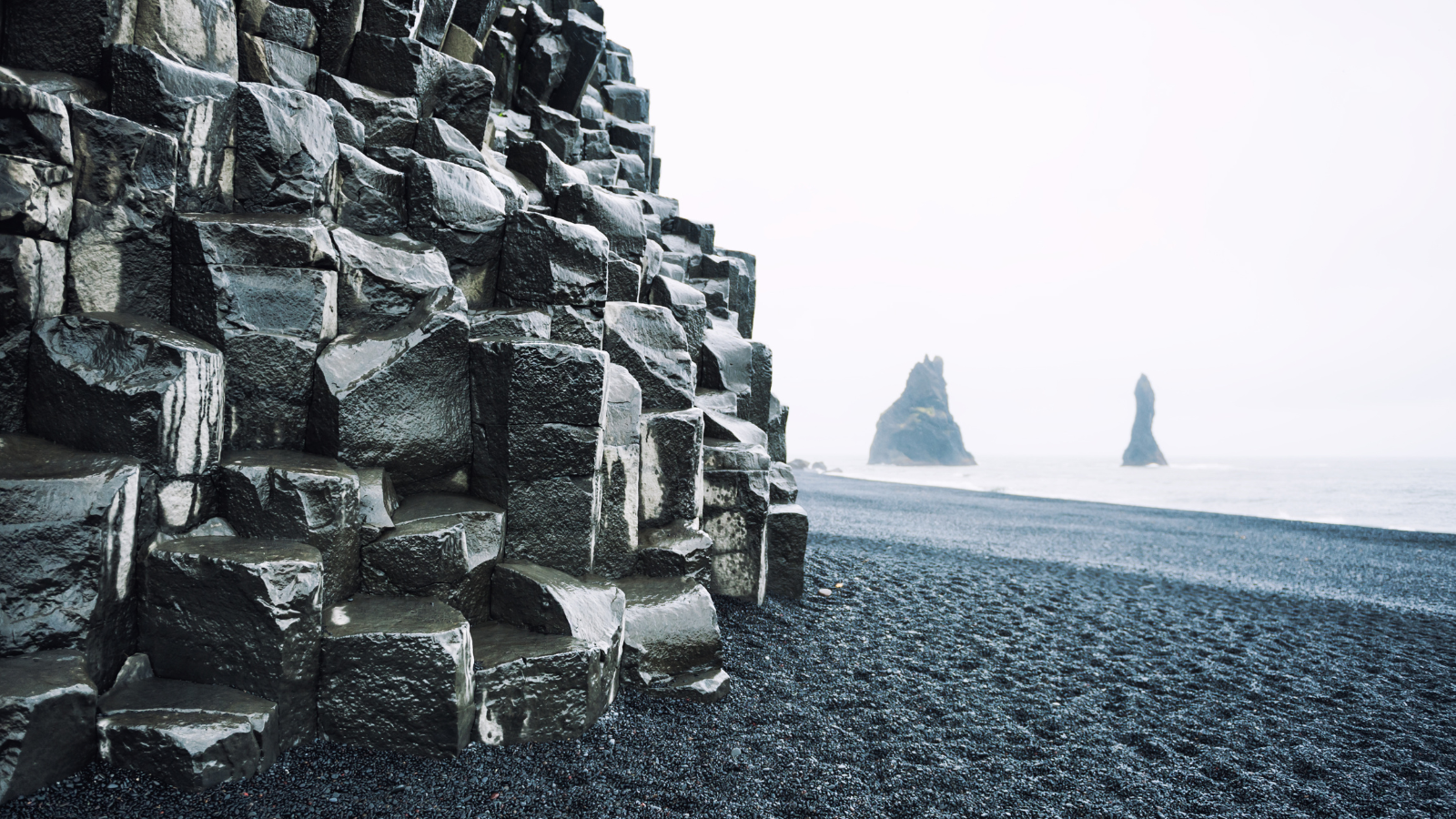 Rock formation on black sand beach in Iceland