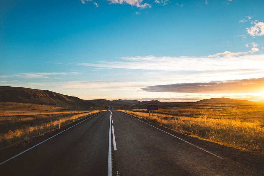 Golden sunset on an asphalt road in Iceland.